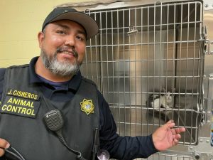 cat stuck-Officer Jose Cisneros at the shelter with kitty