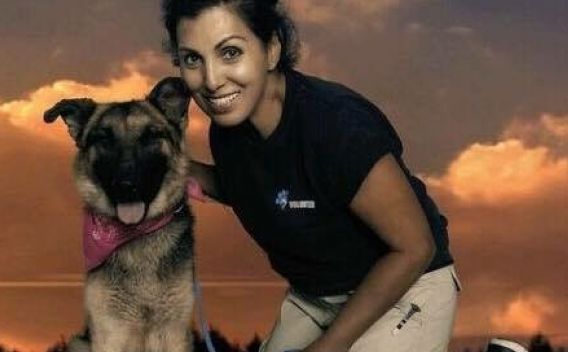 Volunteer Donna C posing with dog